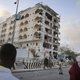 Somalis observe the destruction of Jazeera Palace Hotel following a suicide car bomb attack in the capital Mogadishu.
